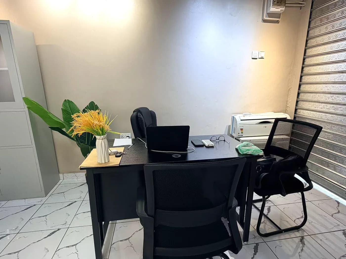 A second view of the office showing the meeting desk and printer